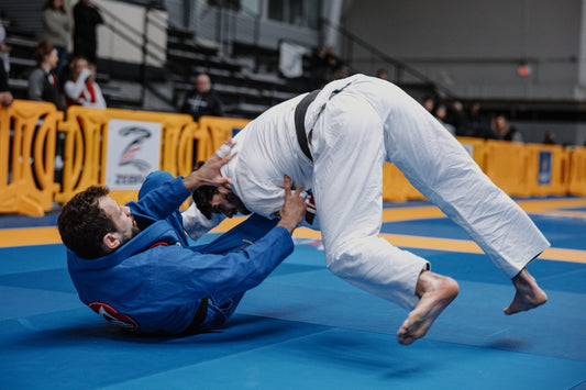 Brazilian Jiu-Jitsu athlete performing a toreando pass to side control during competition.