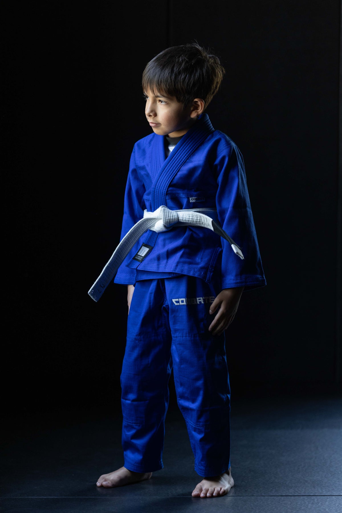 Young boy wearing a blue martial arts gi with a white belt